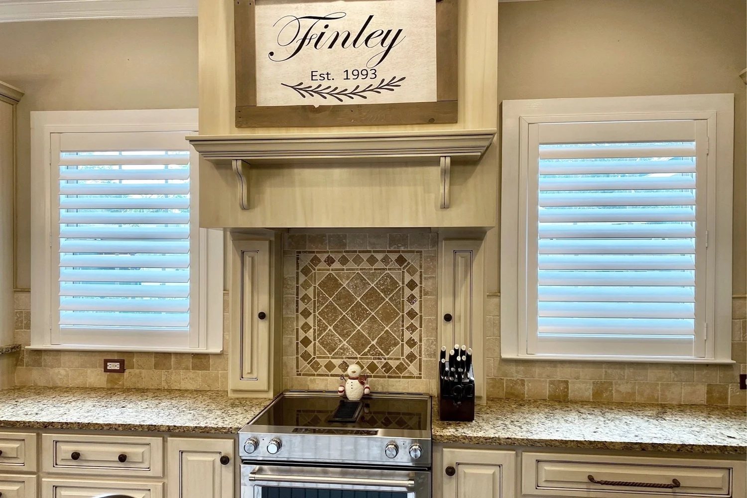 Kitchen windows with horizontal blinds tilted for daylight