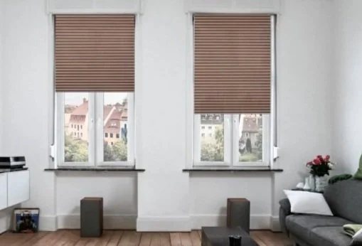 Living room with manual shades lowered across two windows