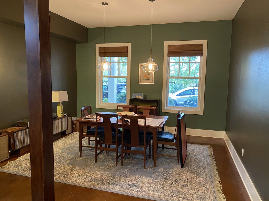 Dining room with coordinated manual shades and pendants