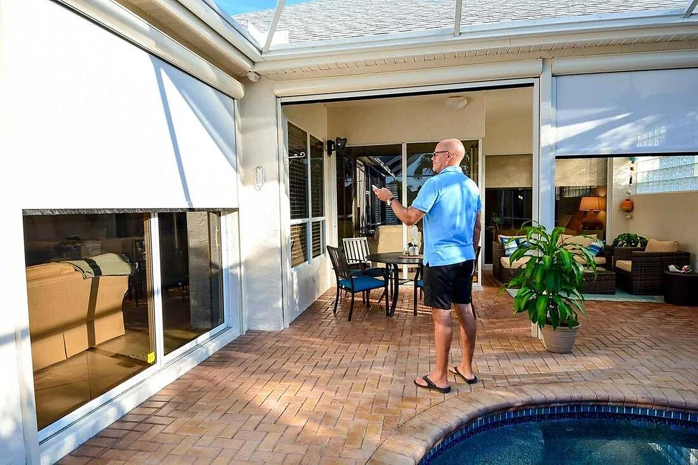 Screened porch and pool with exterior roller shades